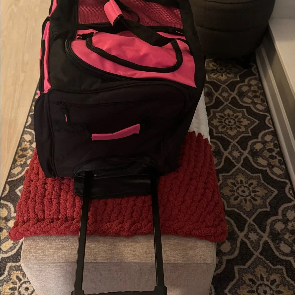 Pink and Black Garment Bag with Wheels 30” long• 16” wide• 14” high